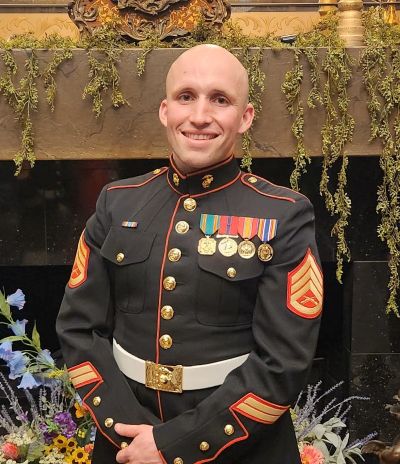 young man smiling in military uniform