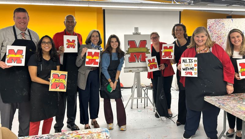 SAAGE members holding M sign