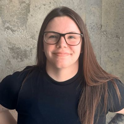 woman with glasses smiling