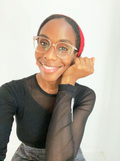 woman with glasses smiling