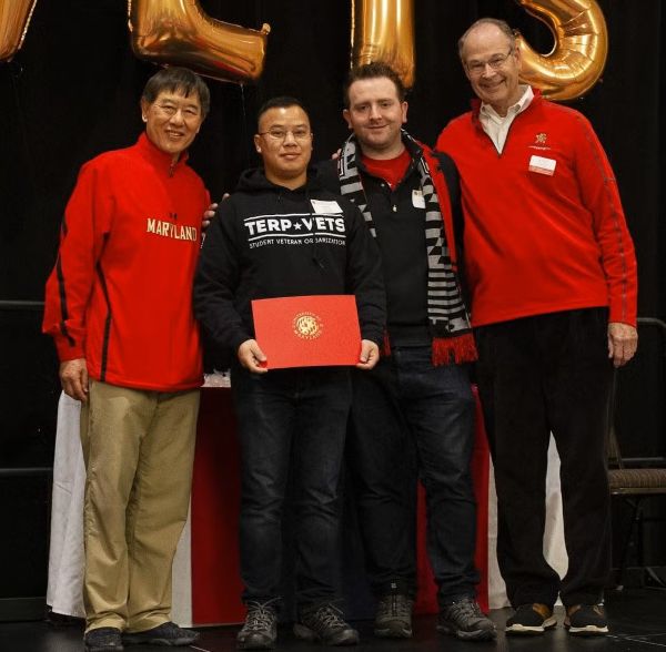 group photo of Yaggya  and former UMD president Wallace D. Loh, and two others