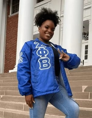 Aniah smiling in front of building