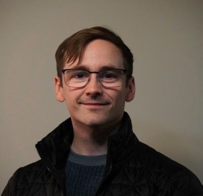 man with glasses smiling