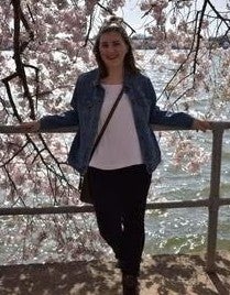 woman standing under cherry blossom tree