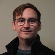 man wearing glasses and a jacket