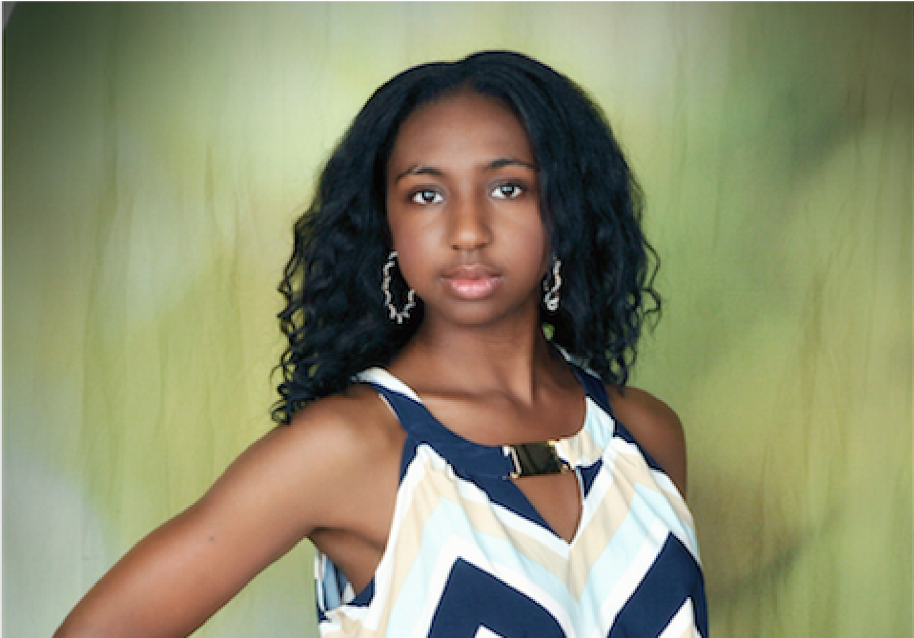 Young woman with a soft smile wearing a dress