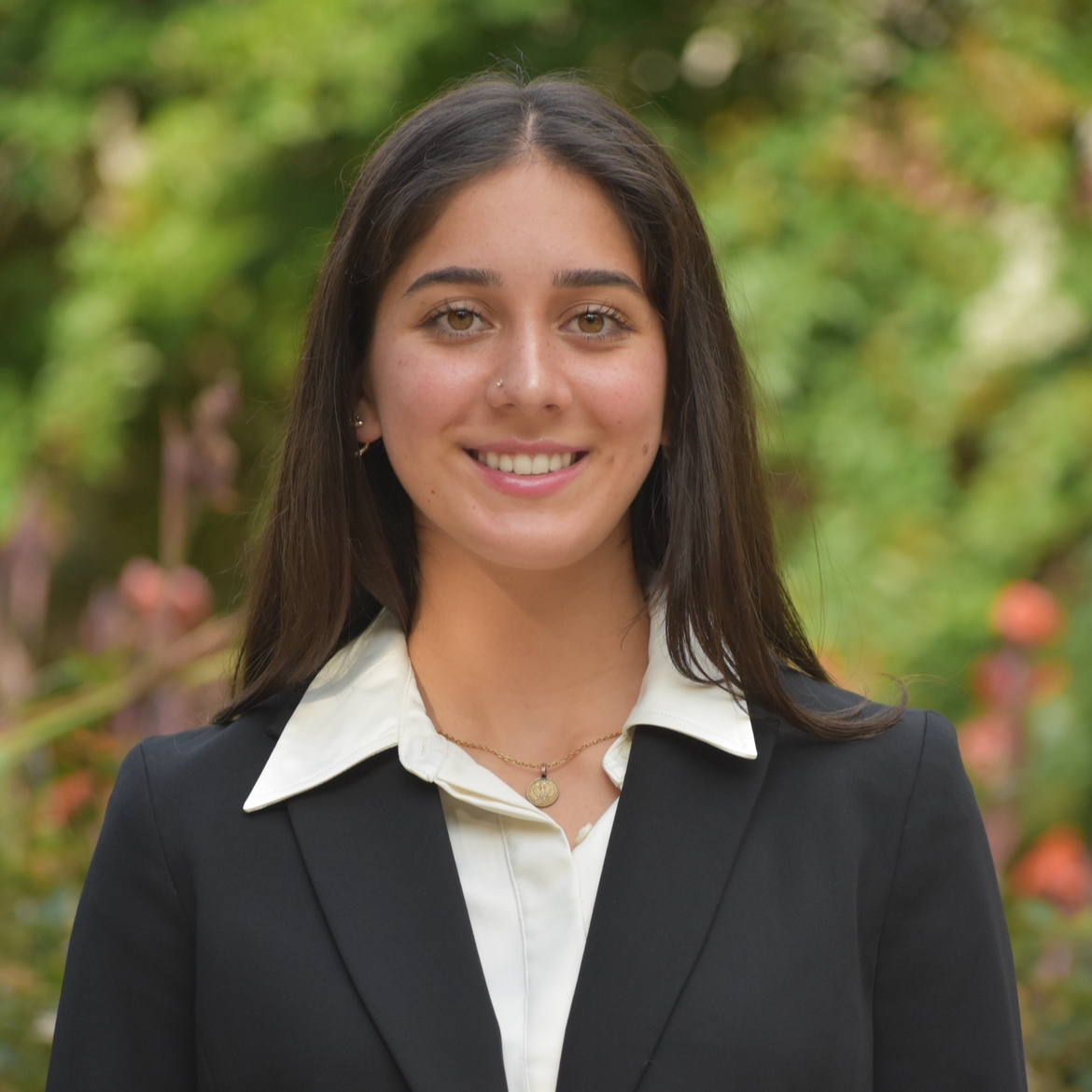 Young woman smiling in a suit.