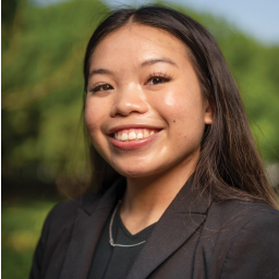 Woman smiling and wearing a suit