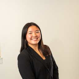 Woman smiling and wearing a suit