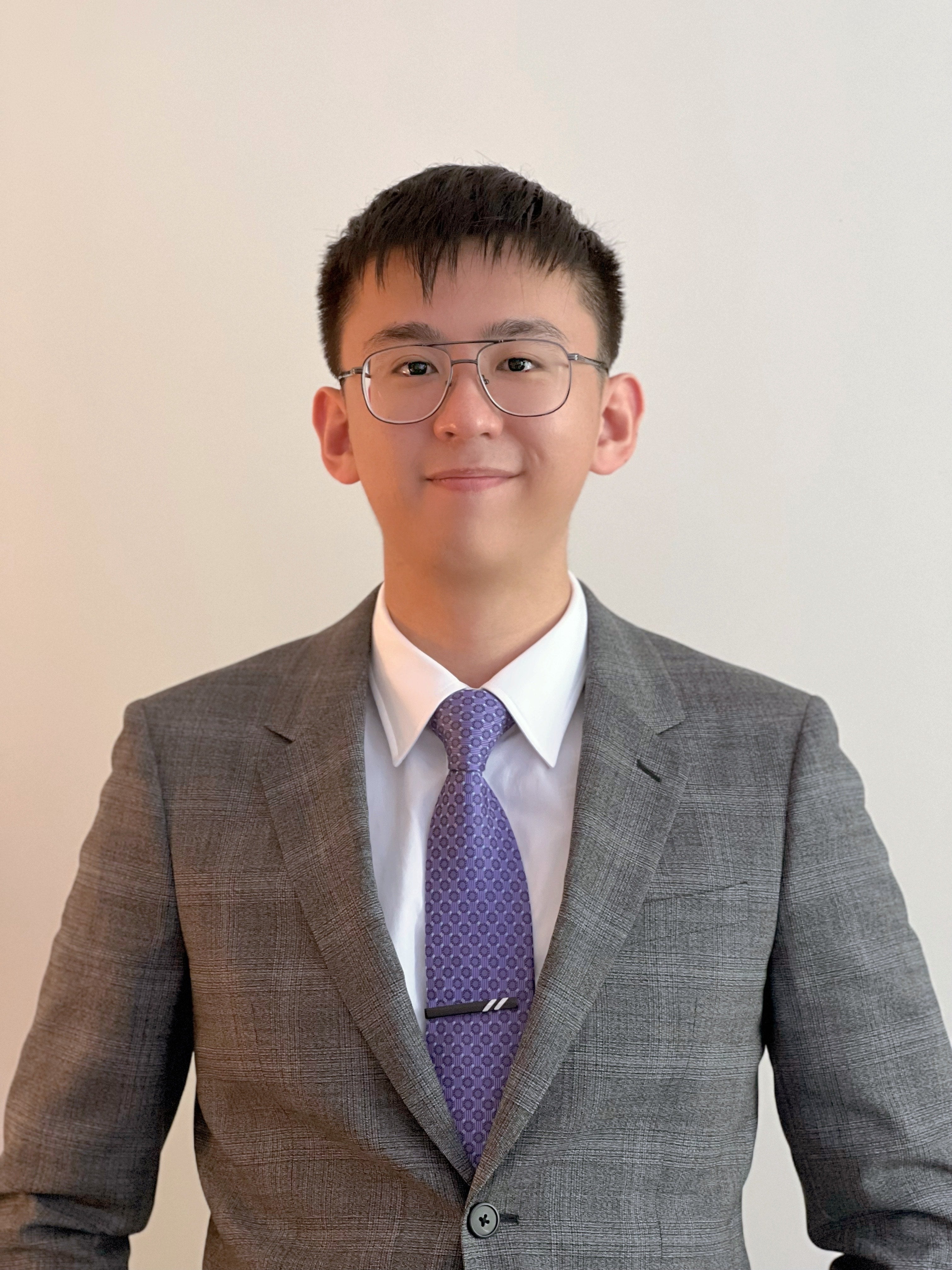 Young man with a soft smile wearing a suit