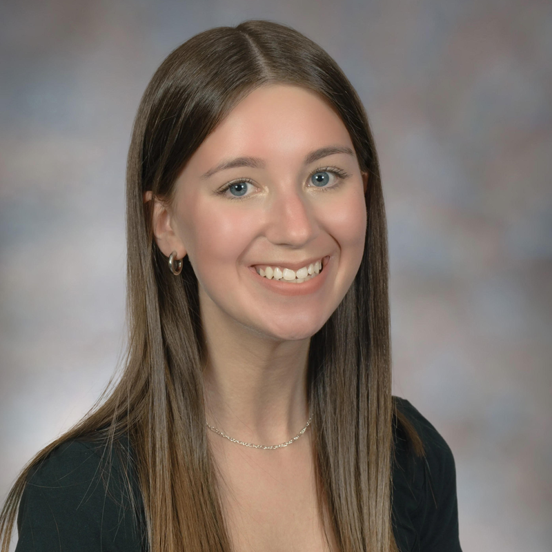 Young woman smiling in a suit
