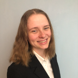 Woman smiling and wearing a suit