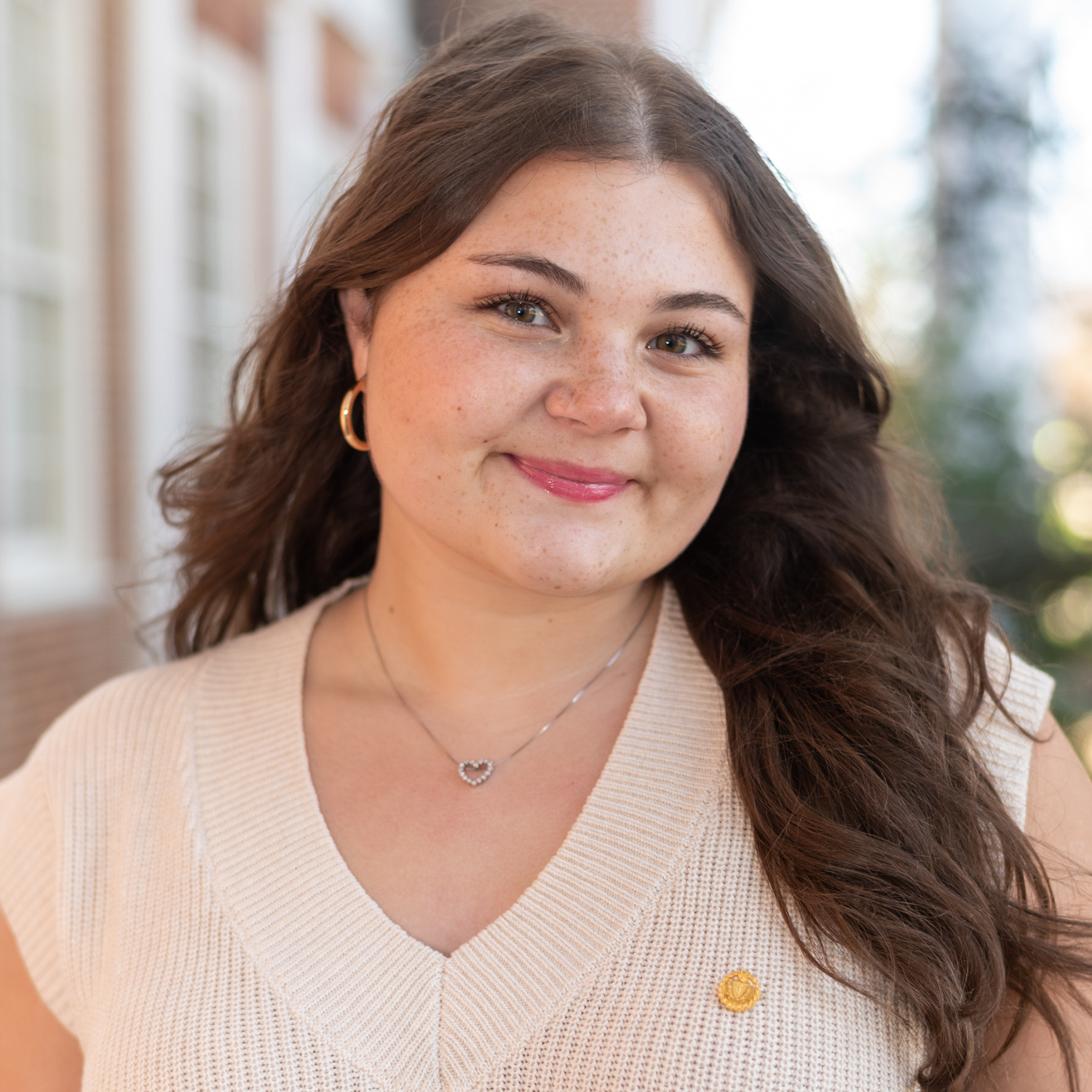 Young woman with a soft smile wearing a blouse