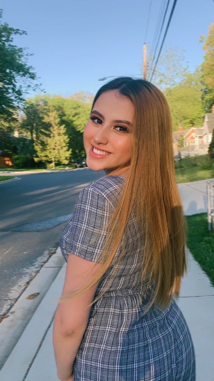 Woman smiling and wearing a dress