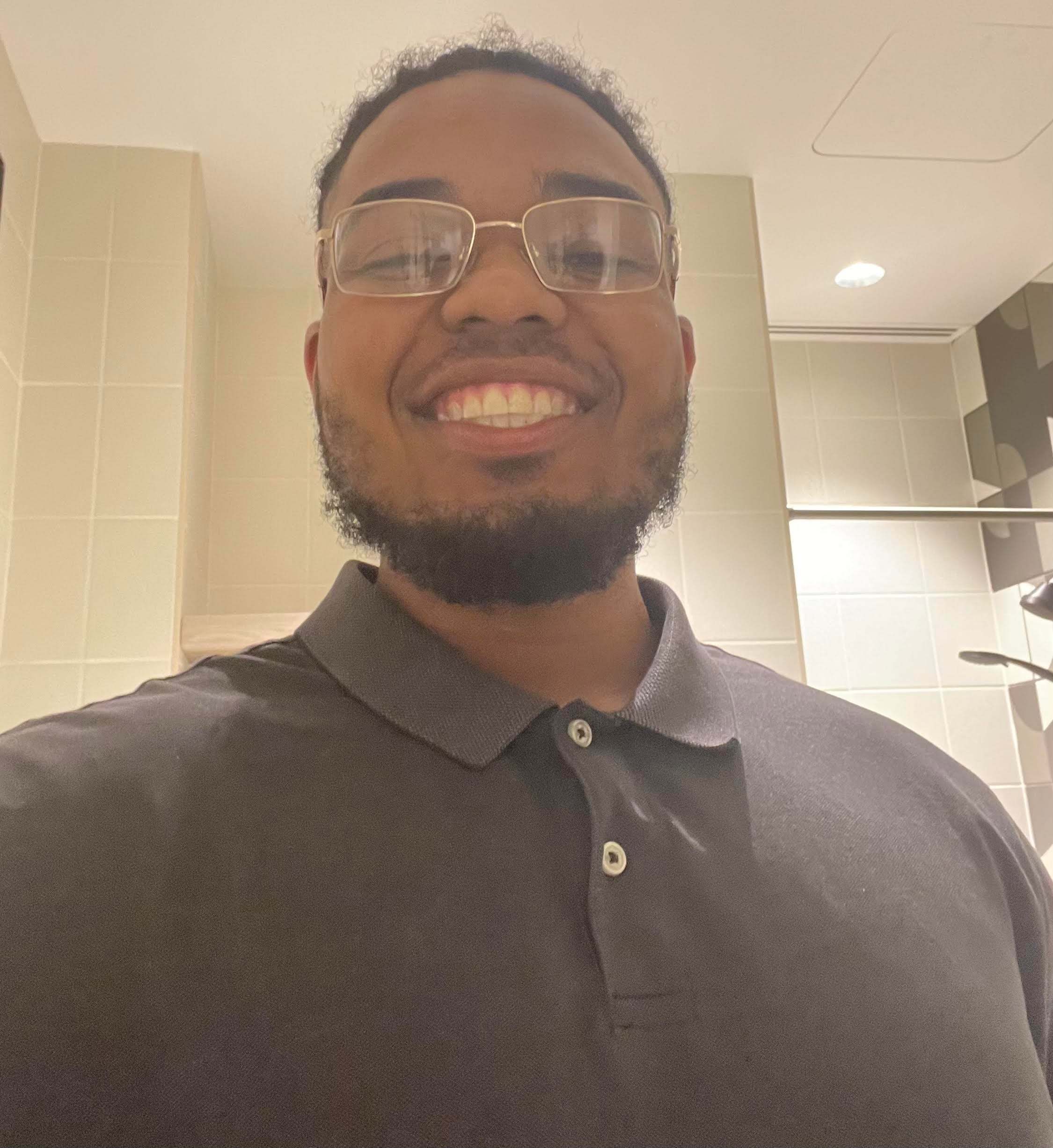 Man smiling and wearing a polo shirt