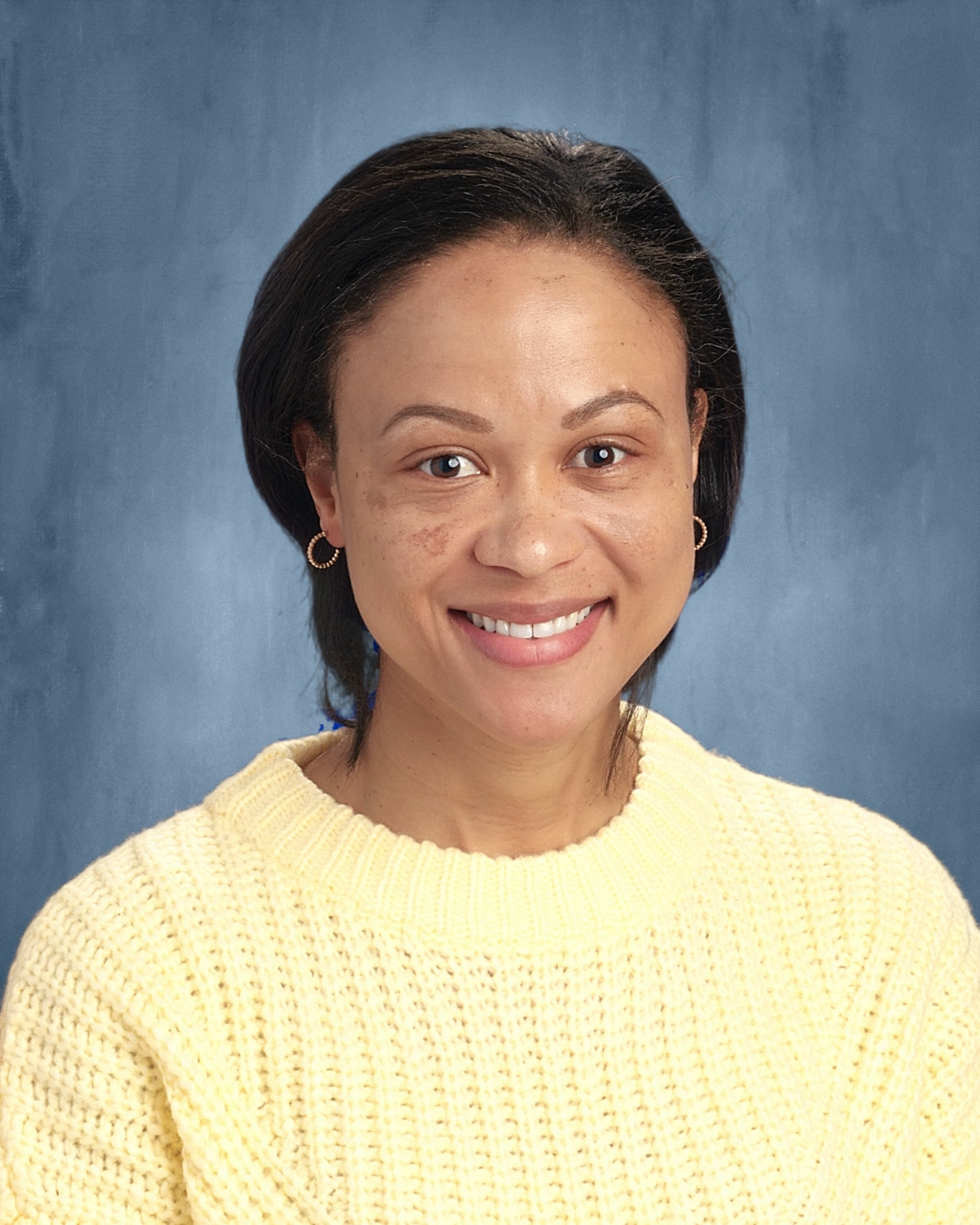Woman smiling and wearing a sweater