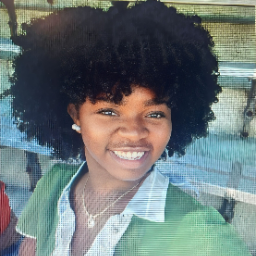 Young woman smiling and taking a selfie.