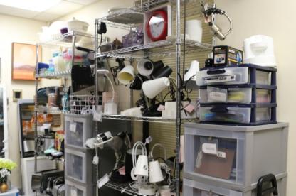 Shelves of donated lamps, kitchenware and school supplies at the Campus ReUse Store.