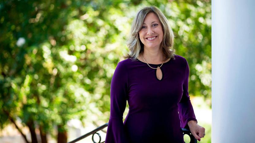 Dean of Students, Andrea Goodwin, stand at the top of a staircase outside on UMD's campus