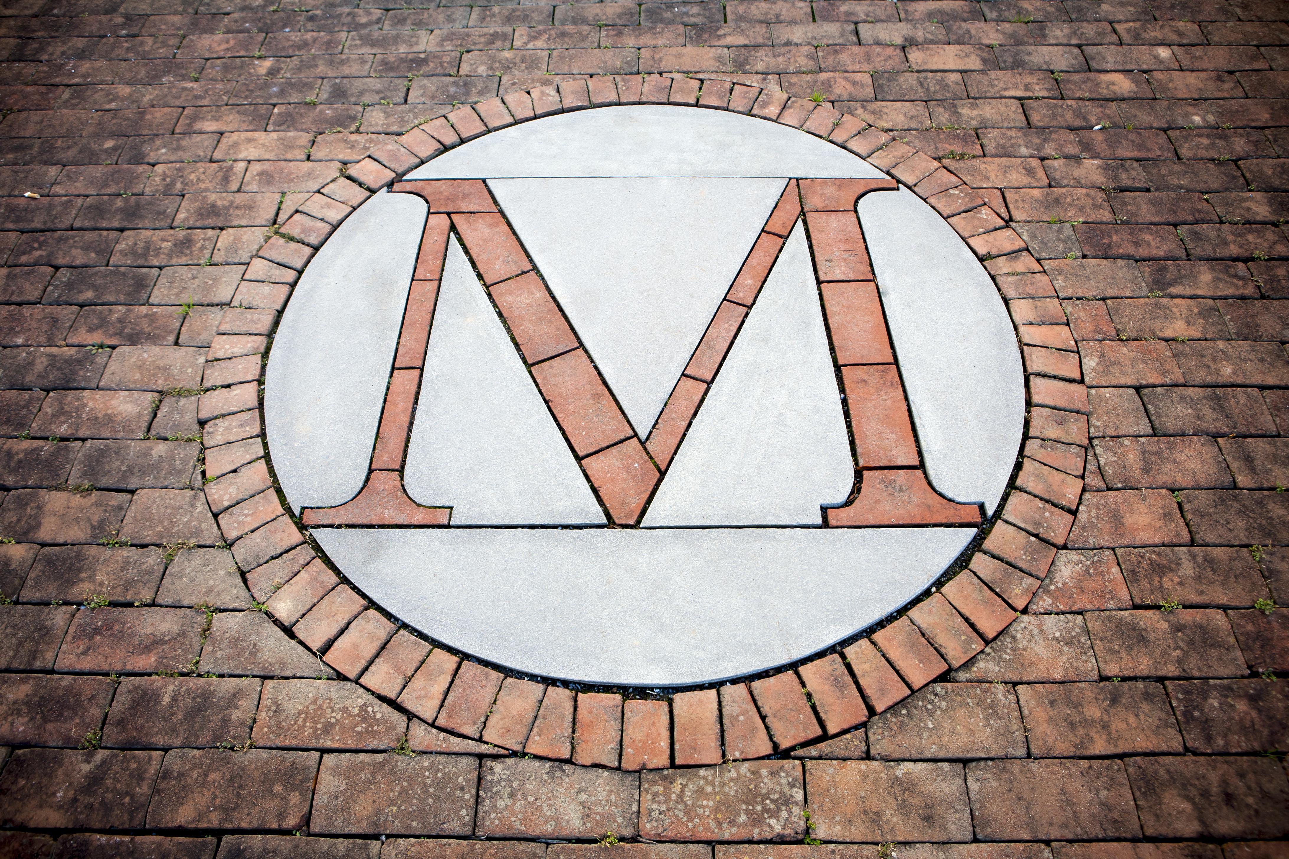 A stylized University 'M' is laid out in bricks on a walkway on campus at UMD