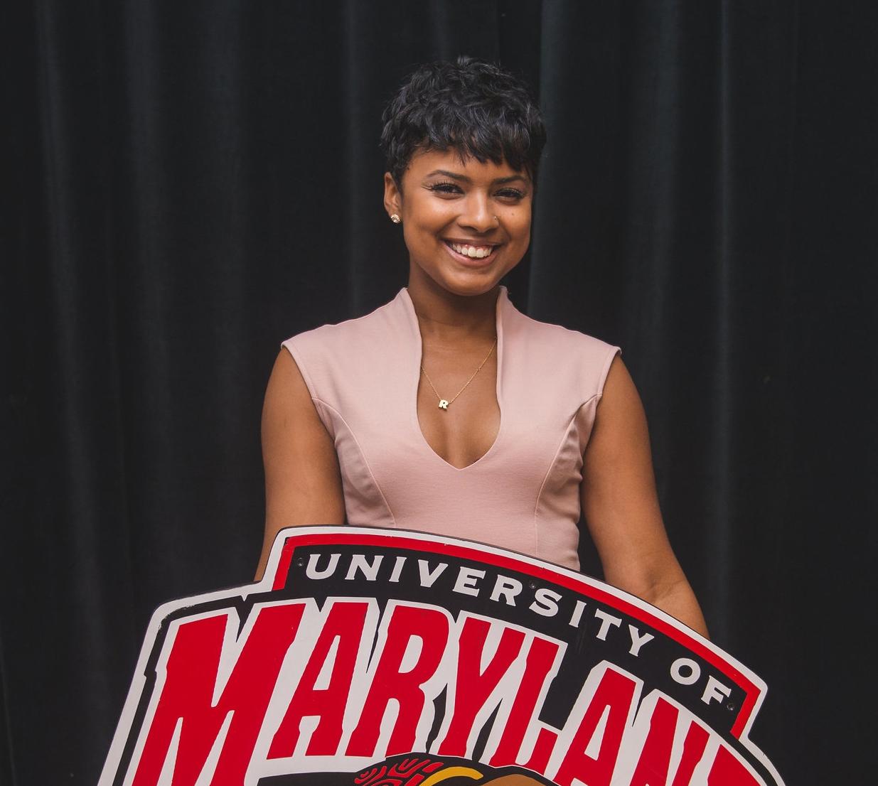 A student holding the university of Maryland banner.