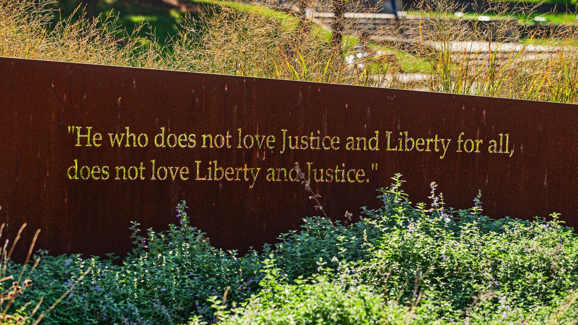 Quote inscribed into a wall: "He who does not love Justice and Liberty for all, does not love Liberty and Justice."