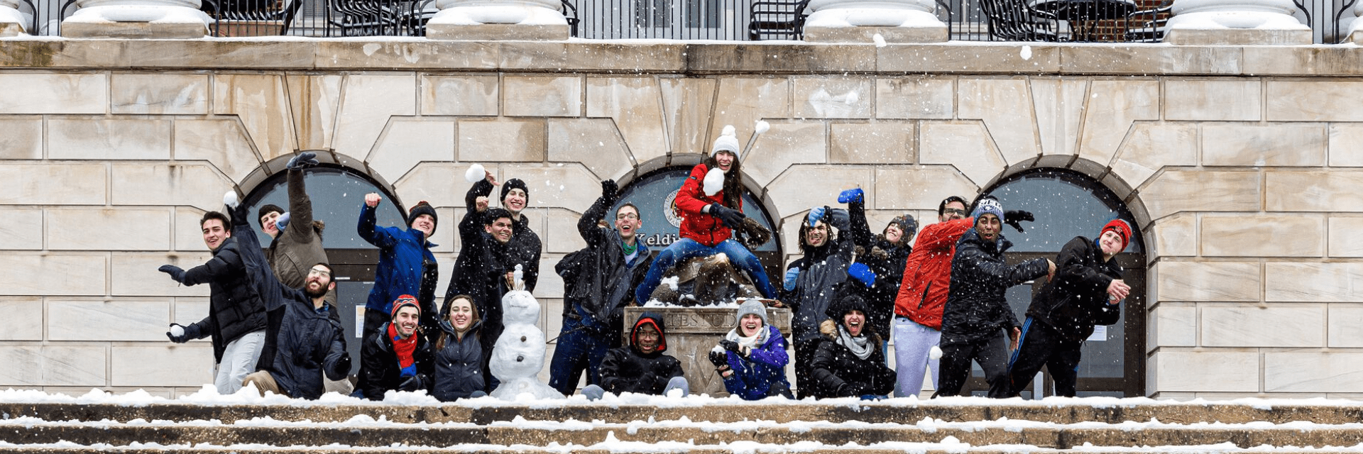 Students standing in front of McKeldin throwing snowballs