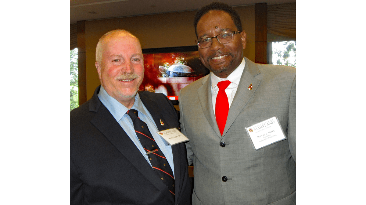 Rocky Lopes standing next to UMD President Darryll Pines. 