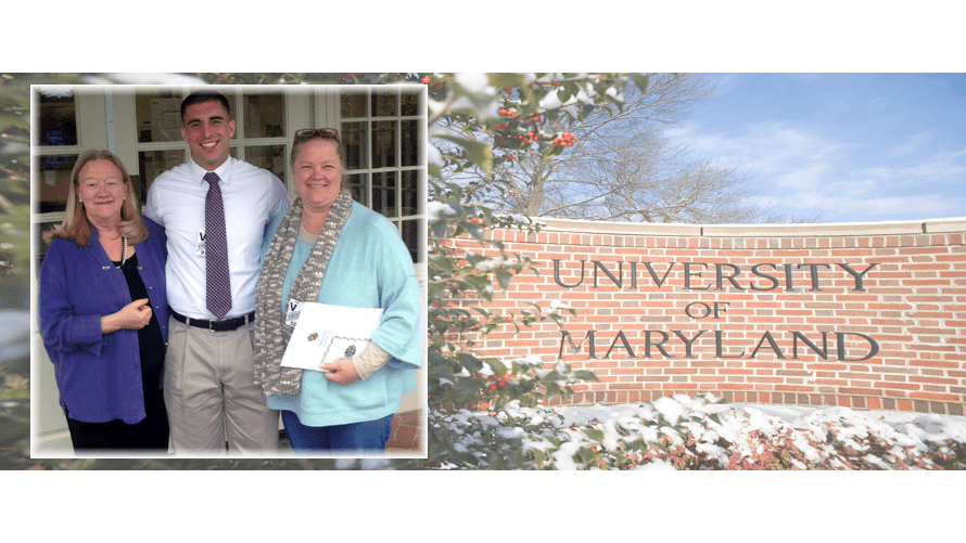 Three people standing next to the University of Maryland welcome sign.