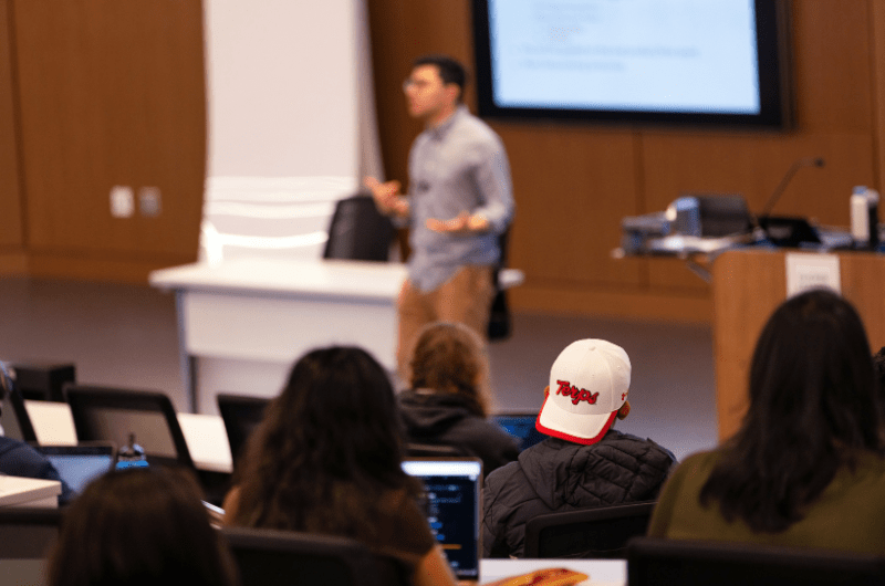 an instructor at the front of the classroom engaging a classroom full of students