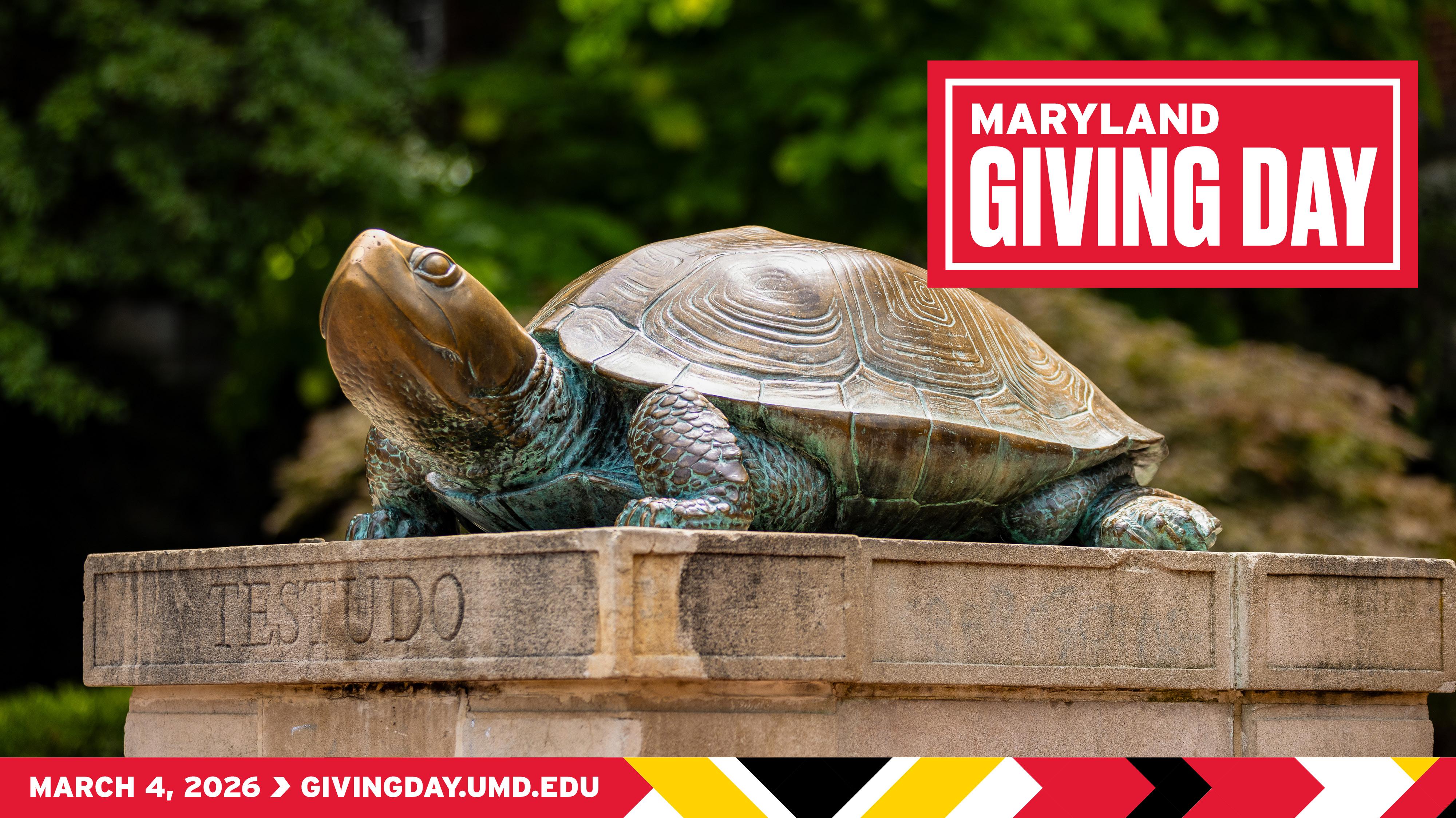 Bronze Testudo statue on the University of Maryland campus with the Maryland Giving Day logo