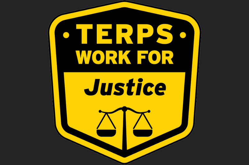 Yellow and black shield badge with a scales icon and text: Terps work for justice.